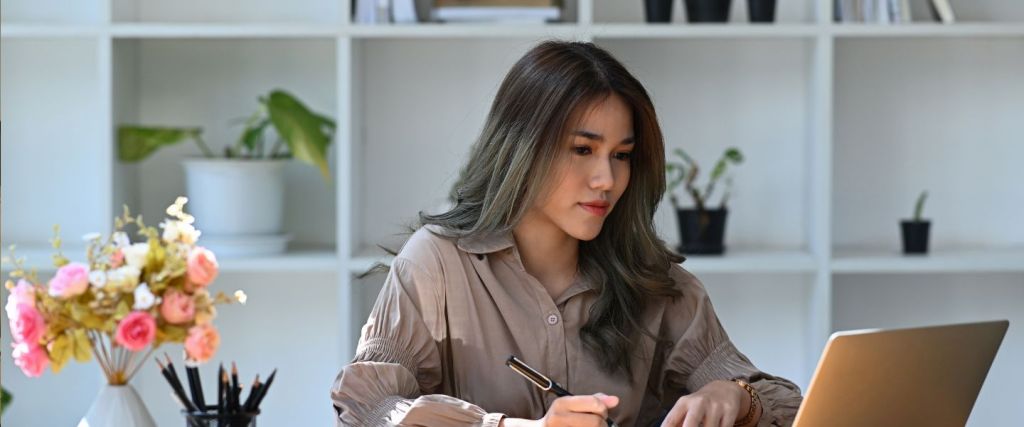 Lady in office working on laptop